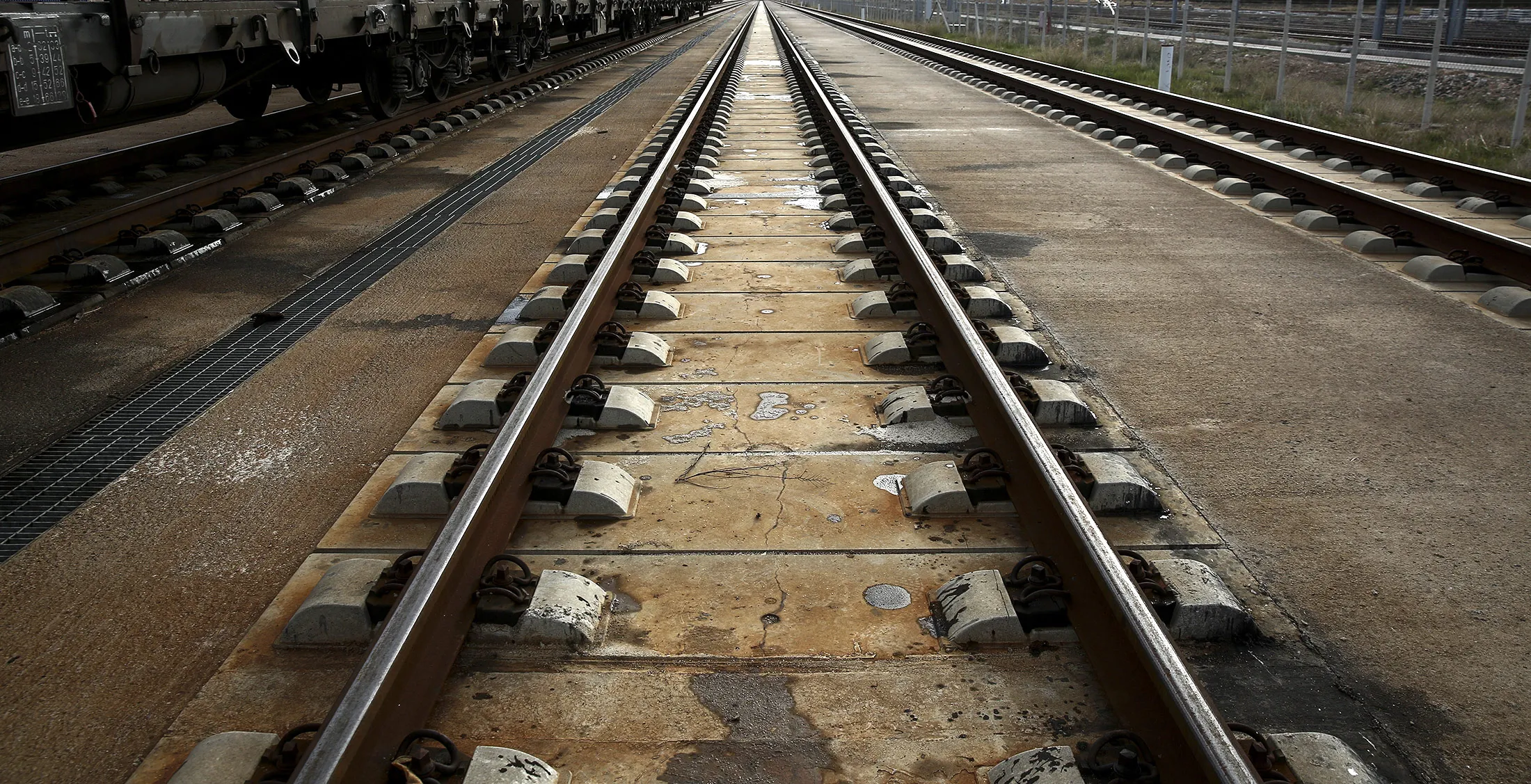An empty rail track on concrete sleepers sits at the Thriasio freight center in Aspropirgos, Greece, on Thursday, Dec. 17, 2015. Binding offers for Greek rail-services operator Trainose SA and train maintenance company Rosco SA will be made in January and for Thessaloniki port in March with both sales to be completed by mid-2016.
