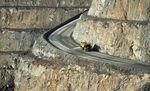 A dump truck travels along an access ramp at an open pit mine.&nbsp;