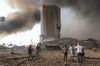 Residents look at a damaged wheat silo and devastation following a large explosion at the Port of Beirut in Beirut, on Aug. 4.