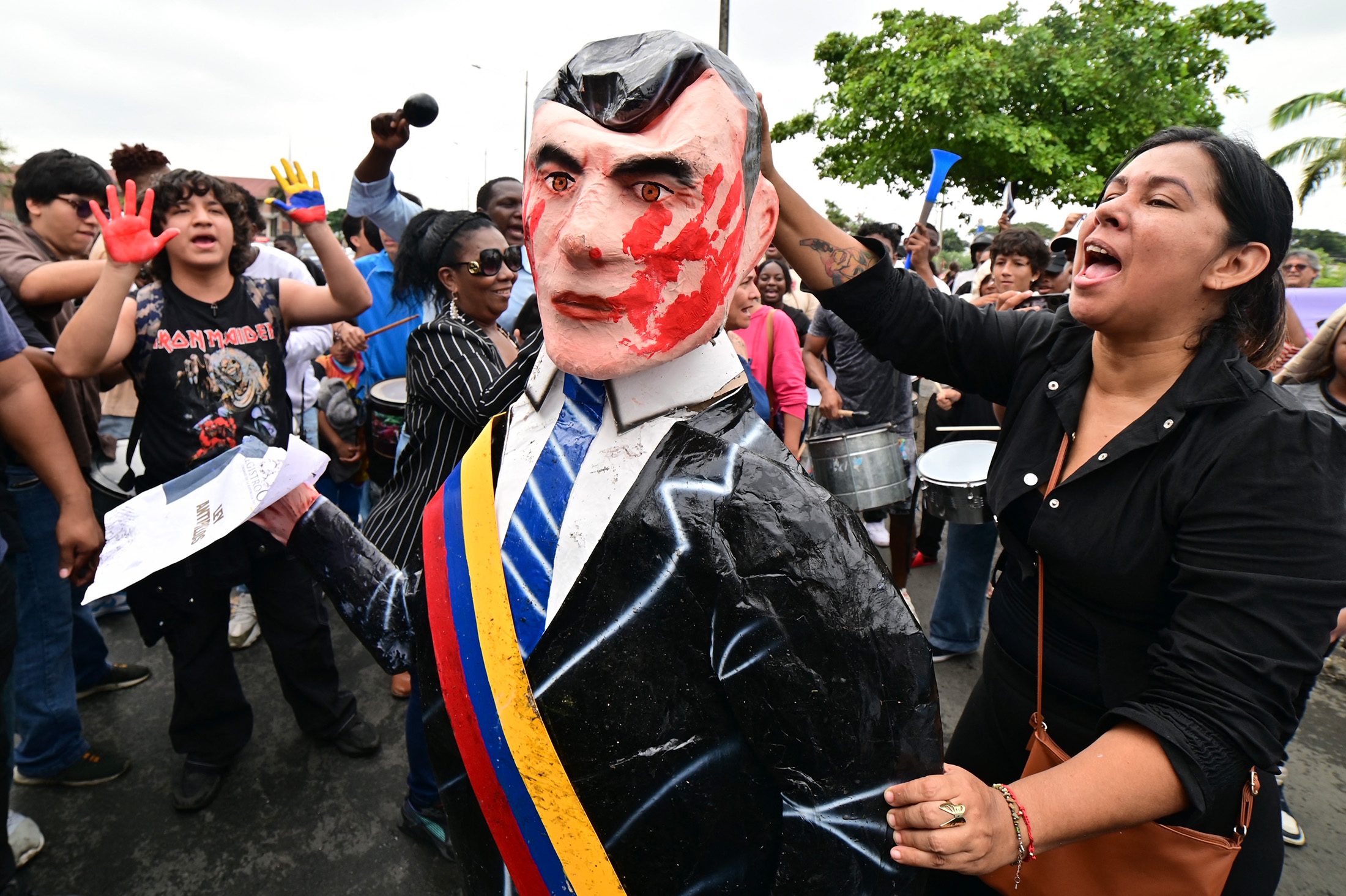 A protester holds an effigy of President Daniel Noboa during a demonstration against the disappearance of four minors who went missing during a military operation, outside the courthouse in Guayaquil, Ecuador, on Dec. 31, 2024. Photographer: Marcos Pin/AFP/Getty Images