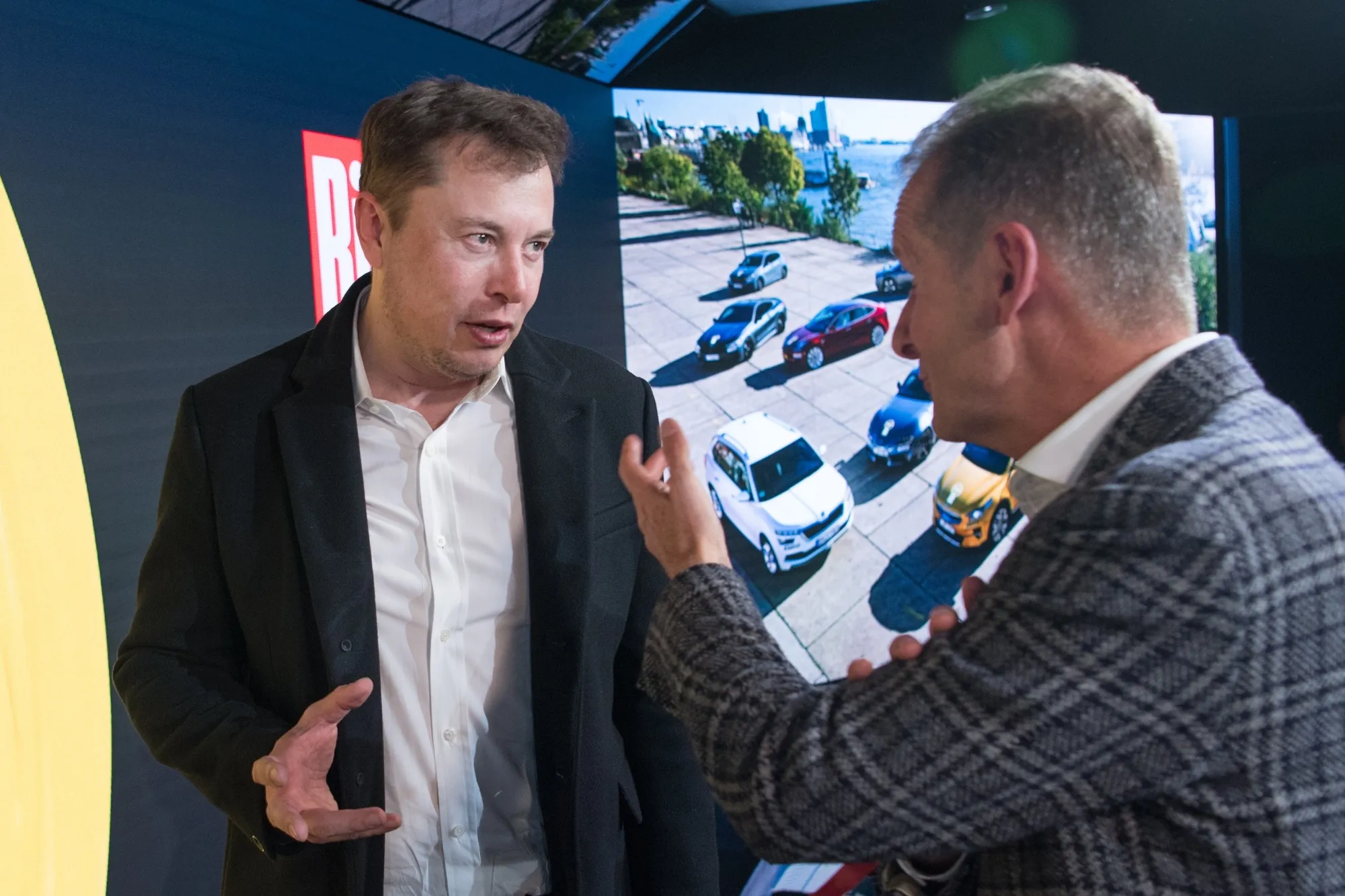 Musk and Diess: Brothers in electric arms.