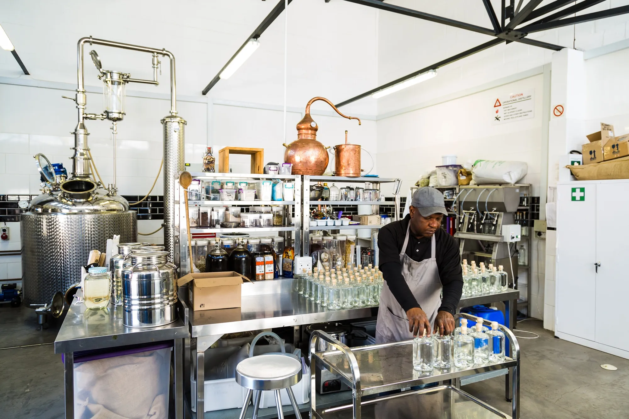 Worker in a small scale gin distillery business