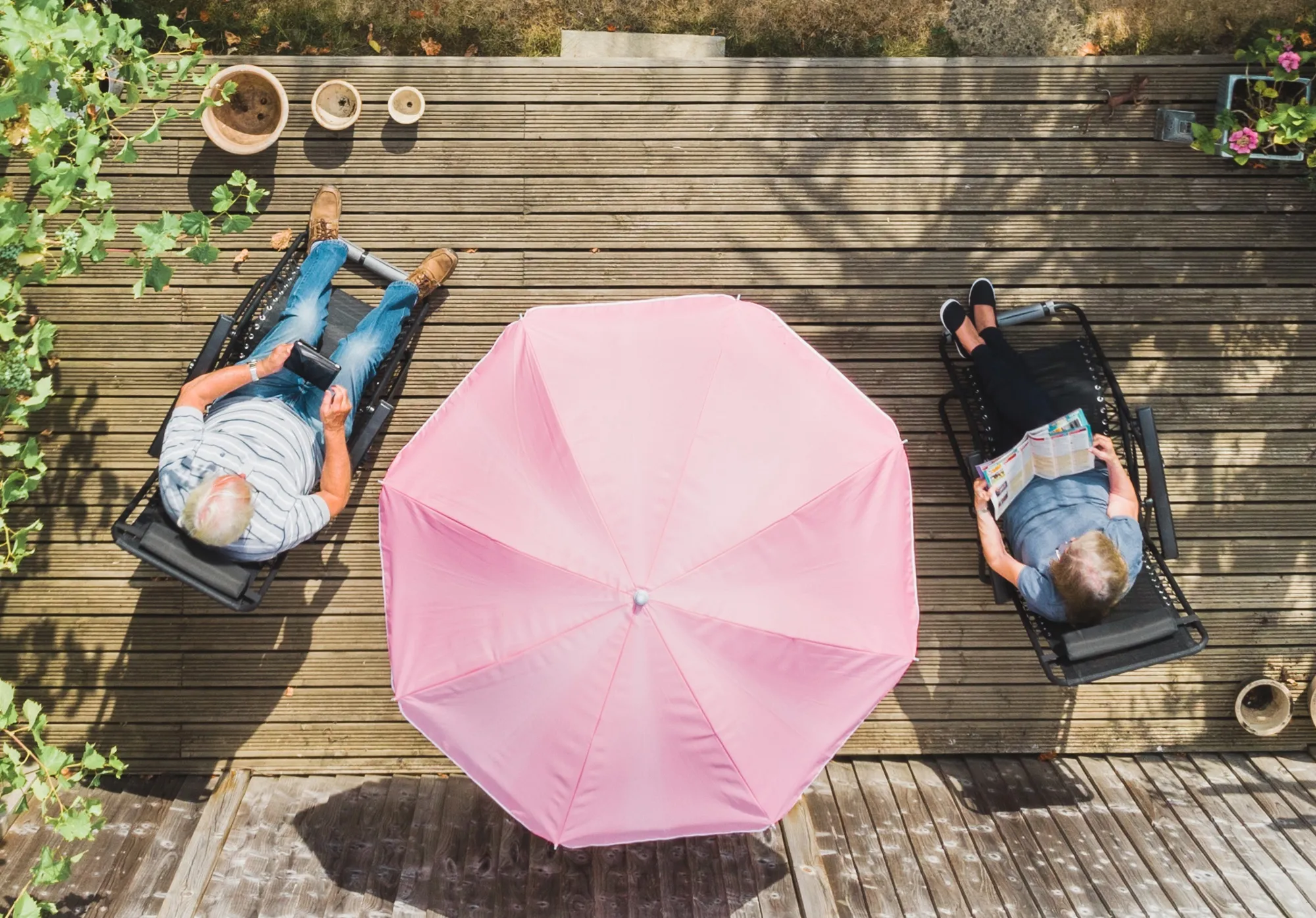 A couple relaxing in a suburban garden summer