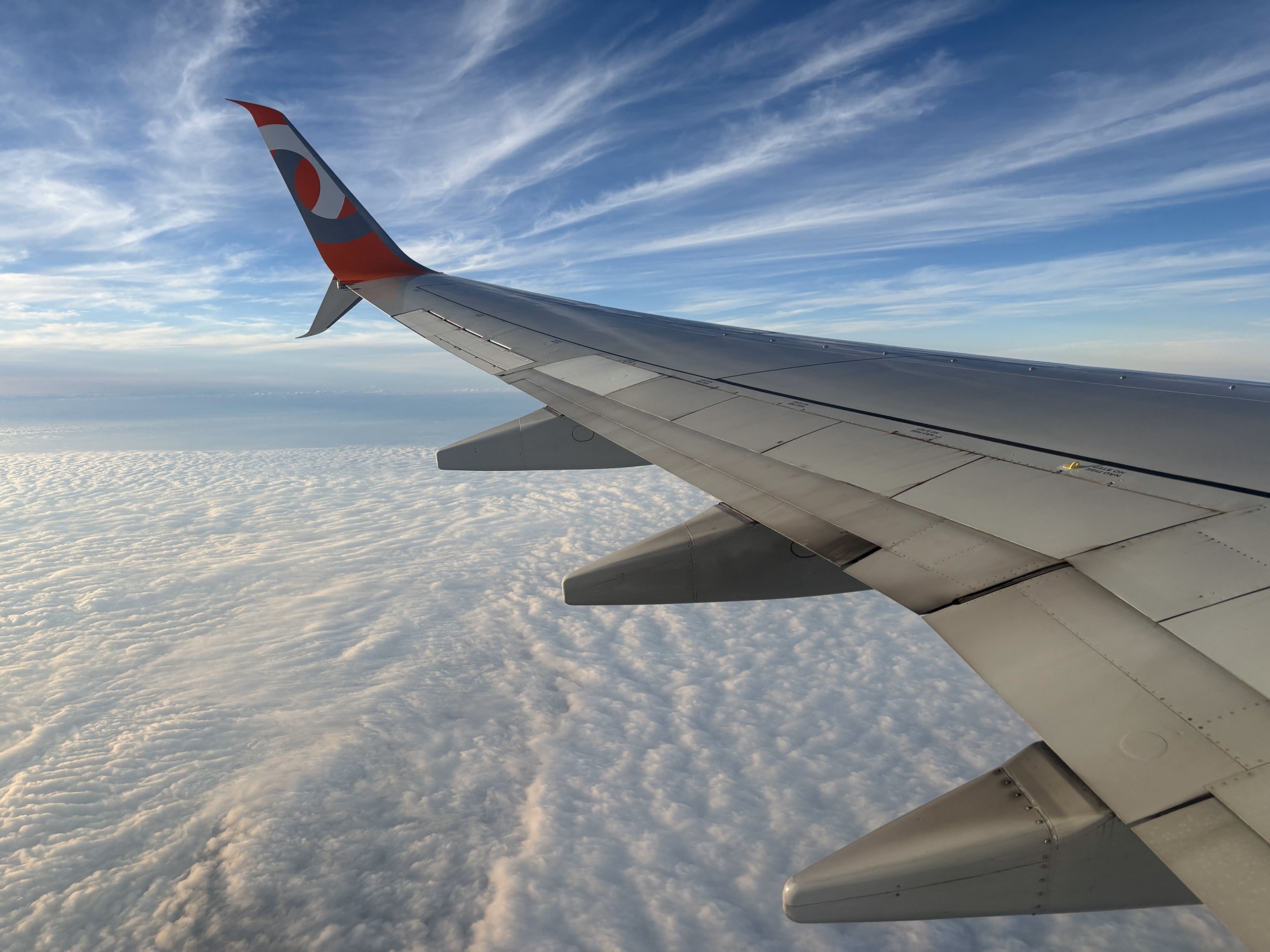 The wing of a GOL Airlines plane is seen amid the clouds after taking off from Guarulhos International Airport in Sao Paulo, Brazil, on March 18, 2026. (Photo by Pablo PORCIUNCULA / AFP via Getty Images)