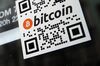 A sticker on the window of a local pub indicates the acceptance of Bitcoins for payment.