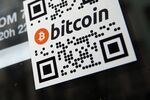 A sticker on the window of a local pub indicates the acceptance of Bitcoins for payment.