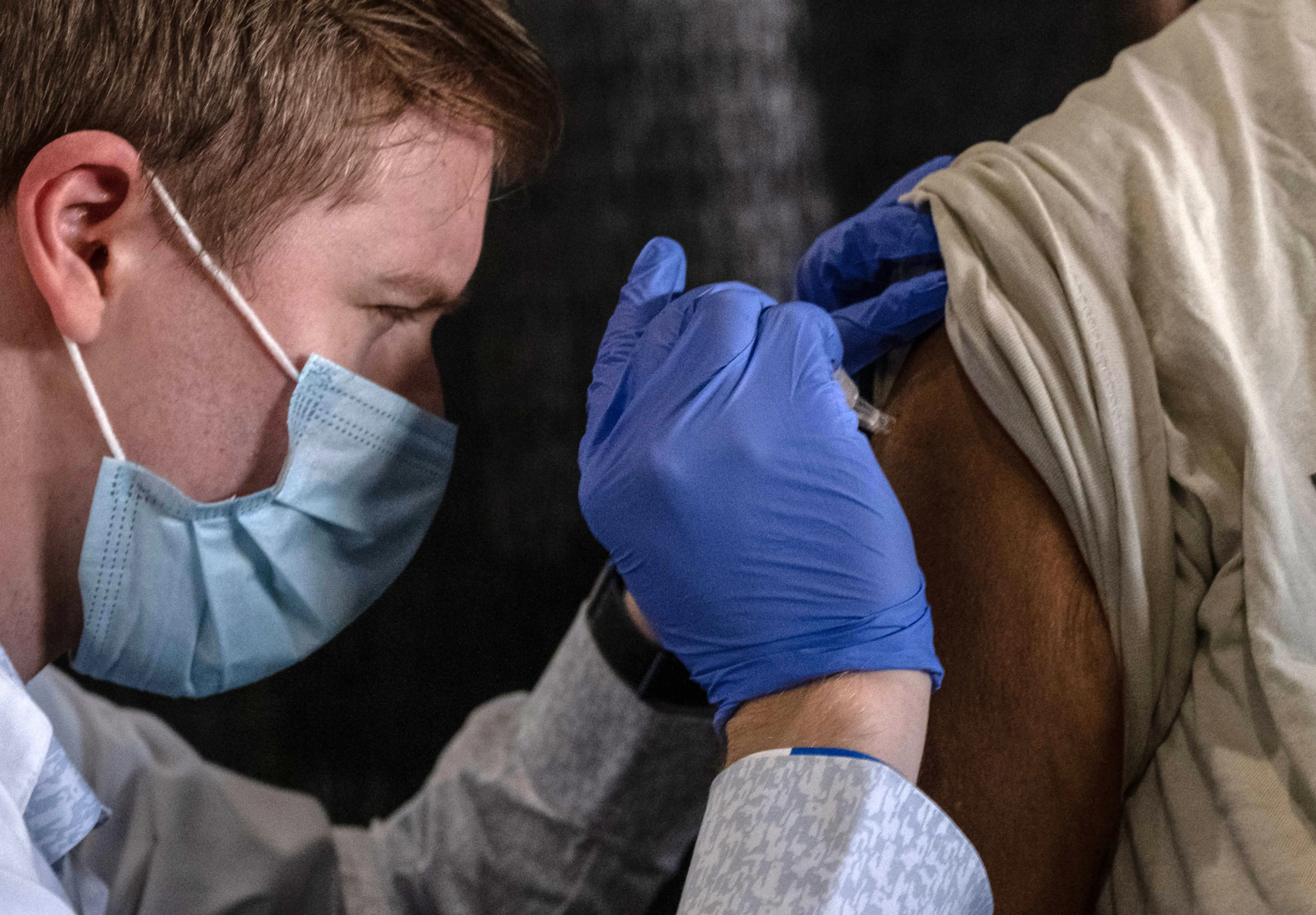 A nurse gives a free flu shot to a patient at Comerica Park in downtown Detroit in November. In many cities, seasonal flu clinics offered a trial run for Covid vaccine distribution.&nbsp;