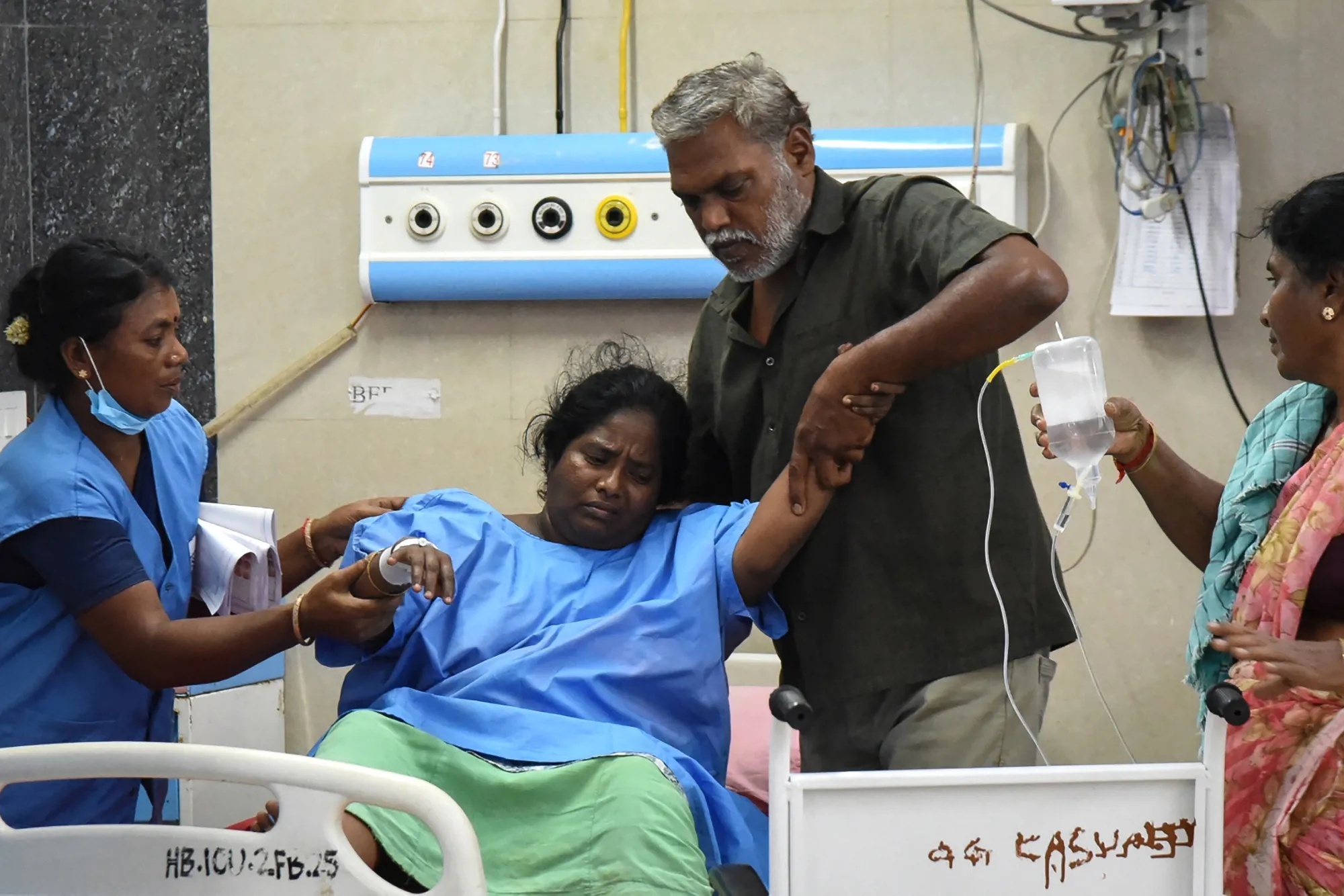 Relatives help a victim getting treatment at a hospital after a stampede broke out during a campaign rally in Tamil Nadu, on Sept. 28.