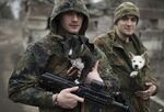 Ukrainian servicemen put their dogs under the jackets to keep them warm in Mariupol, Ukraine.
