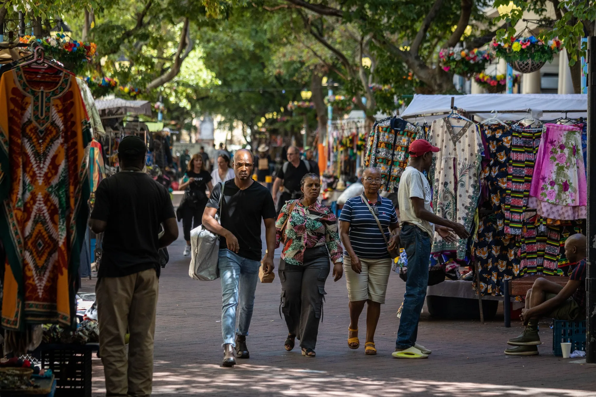 Pedestrians at an outdoor market in St George's Mall pedestrian walkway in Cape Town, South Africa.