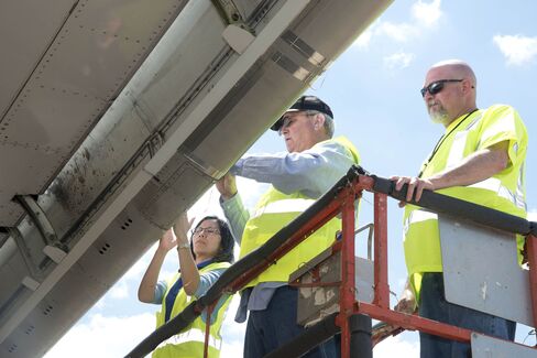 Researchers count insect residue on the wing of the ecoDemonstrator 757 aircraft.