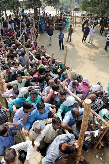 Waiting to exchange discontinued currency notes outside a bank on the outskirts of Allahabad.