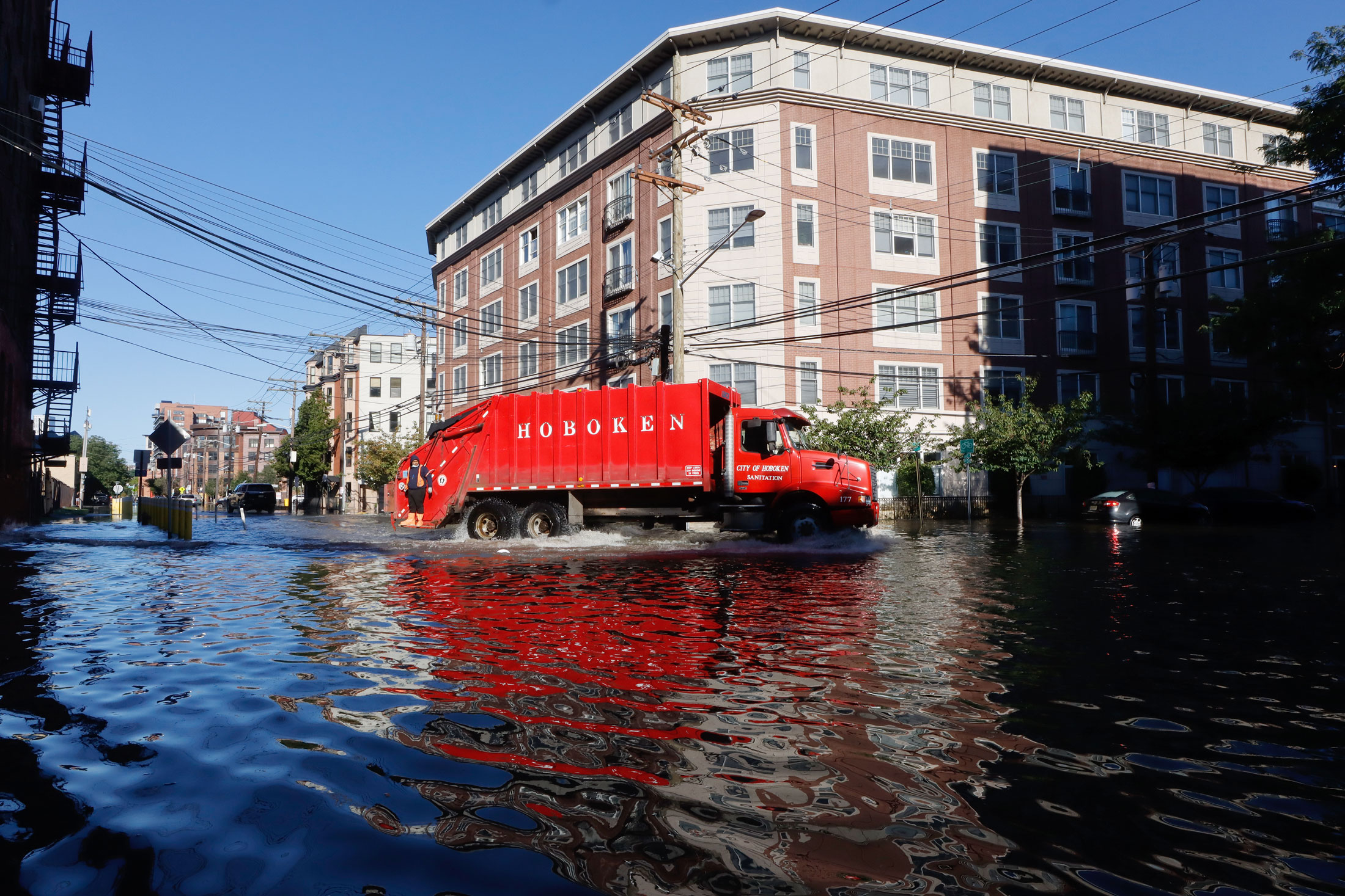 A sanitation truck drives through a flooded street in Hoboken&nbsp;the morning after&nbsp;remnants of Hurricane Ida drenched the New York City and New Jersey area in 2021.