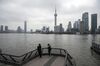 People stand on the Bund in Shanghai, China, on Friday, Feb. 12, 2021. Parts of northern China recently imposed lockdowns to curb coronavirus outbreaks and the government has taken steps to discourage millions of people from making their annual trips to their hometowns. That's likely to distort some of the traditional spending at this time of year.