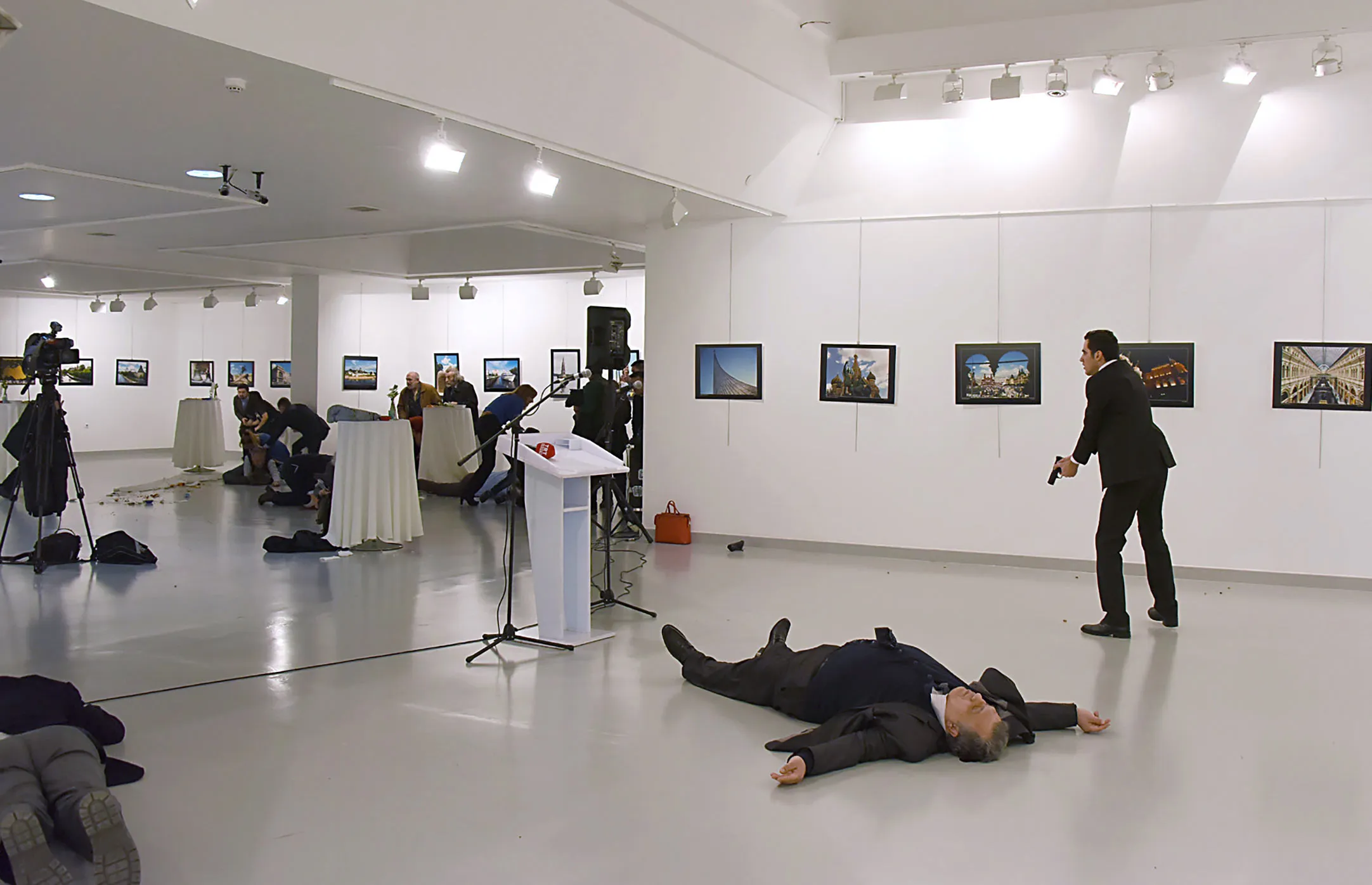 Andrey Karlov, the Russian ambassador to Turkey, is seen lying on the floor after being shot by Mevlut Mert Altintas, right, in Ankara on Dec. 19.

