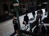 Pedestrians walk along Wall Street near the New York Stock Exchange.