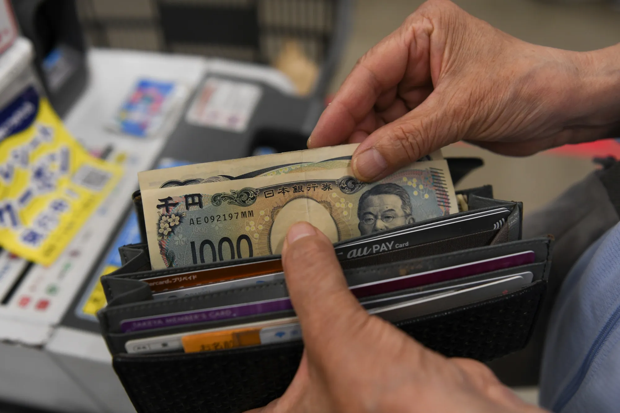 A customer makes a payment at a self-checkout machine in a Takeya store in Tokyo.