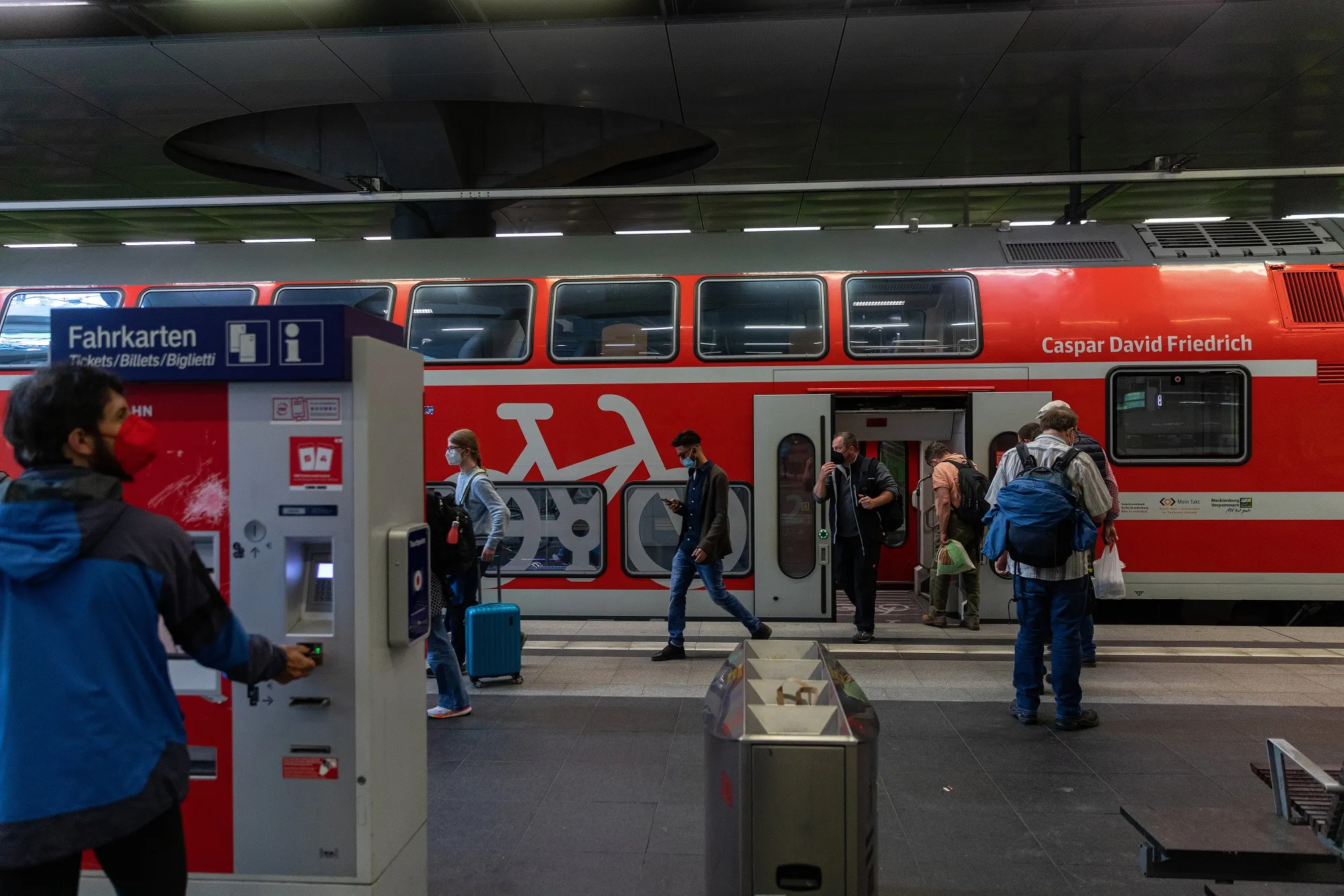 Passengers disembark a Deutsche Bahn AG passenger train on a platform at Berlin Central Station in June.