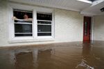 Obrad Gavrilovic peers out the window of his flooded home as waters rise in Bolivia, North Carolina, on September 15, 2018.