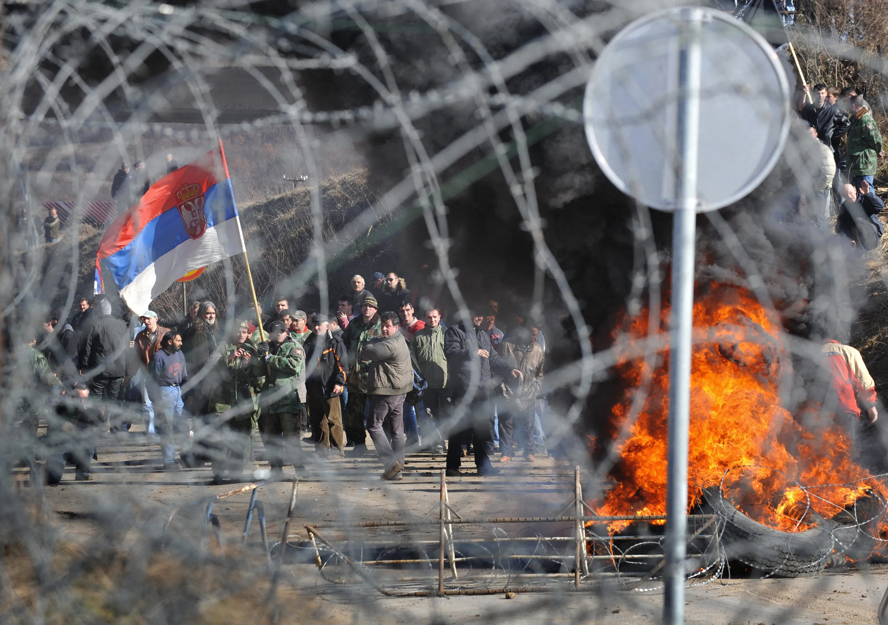 A Serbian protester waves the Serbian national flag at the Merdare border point with Serbia, in&nbsp;2008.&nbsp;