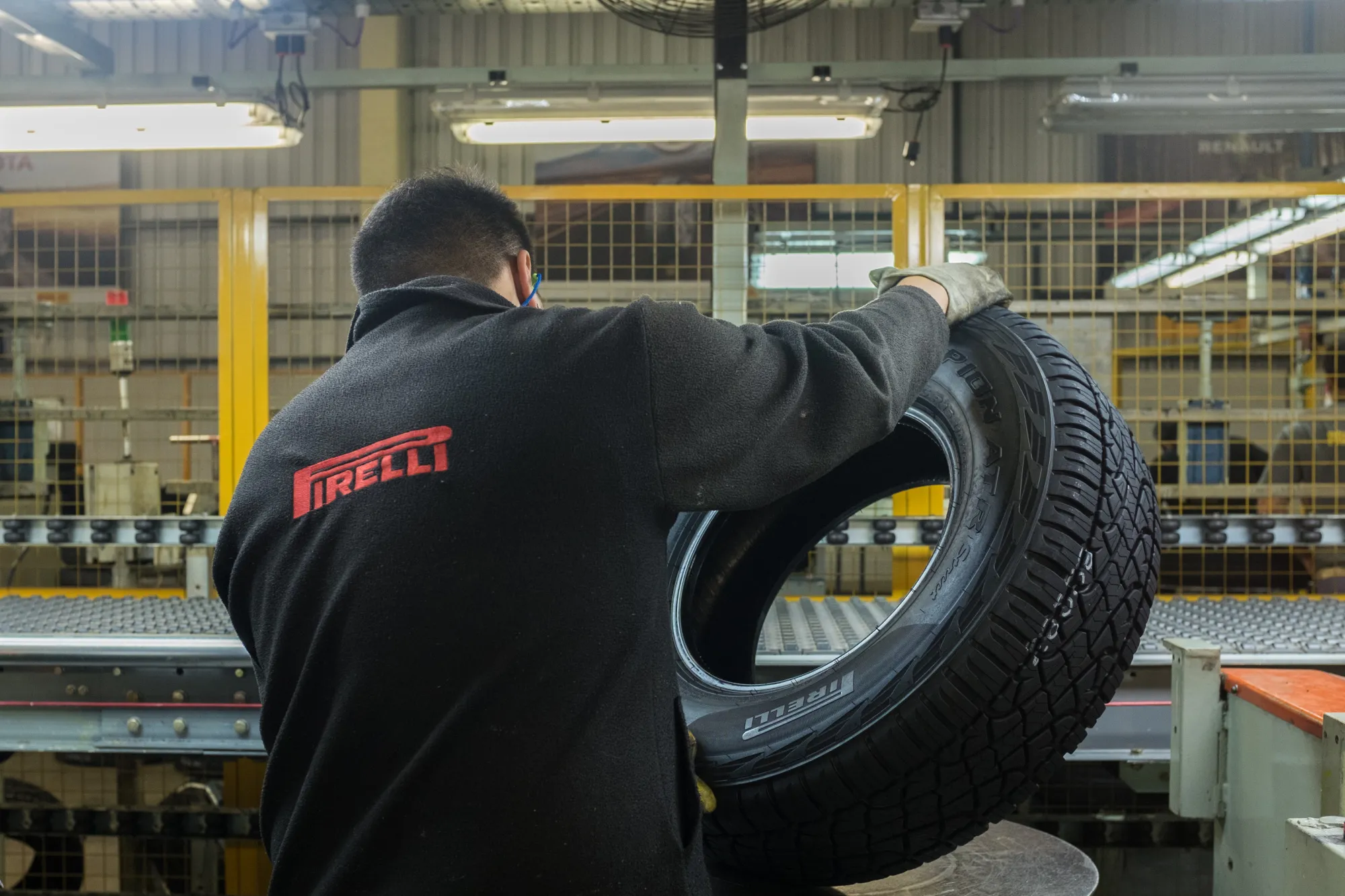An employee inspects an automobile tire at a Pirelli production plant.