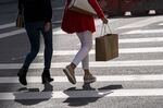A pedestrian carries a shopping bag in San Francisco, California, U.S., on Thursday, Sept. 16, 2021. 