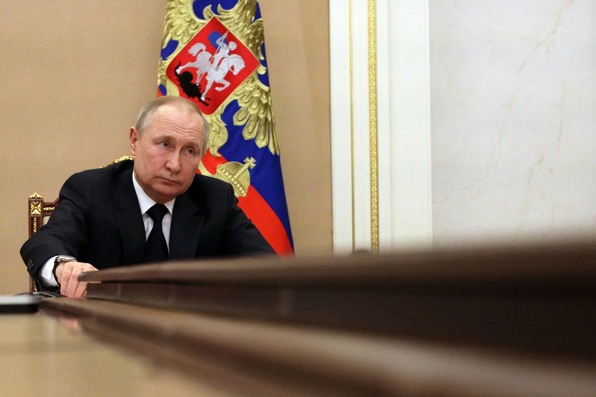 Russian President Vladimir Putin chairs a meeting with members of the Russian government via teleconference in Moscow.