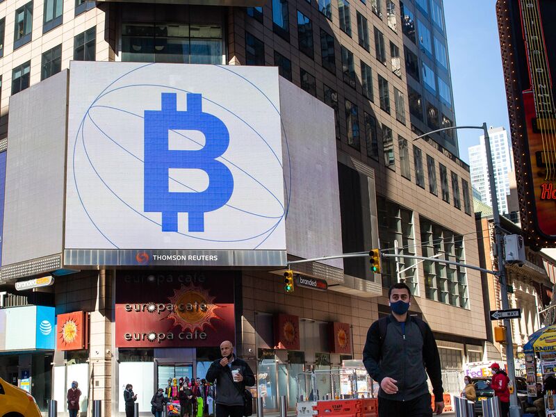 Monitors display Coinbase and Bitcoin signage during the company's initial public offering (IPO) at the Nasdaq MarketSite in New York, U.S., on Wednesday, April 14, 2021. 