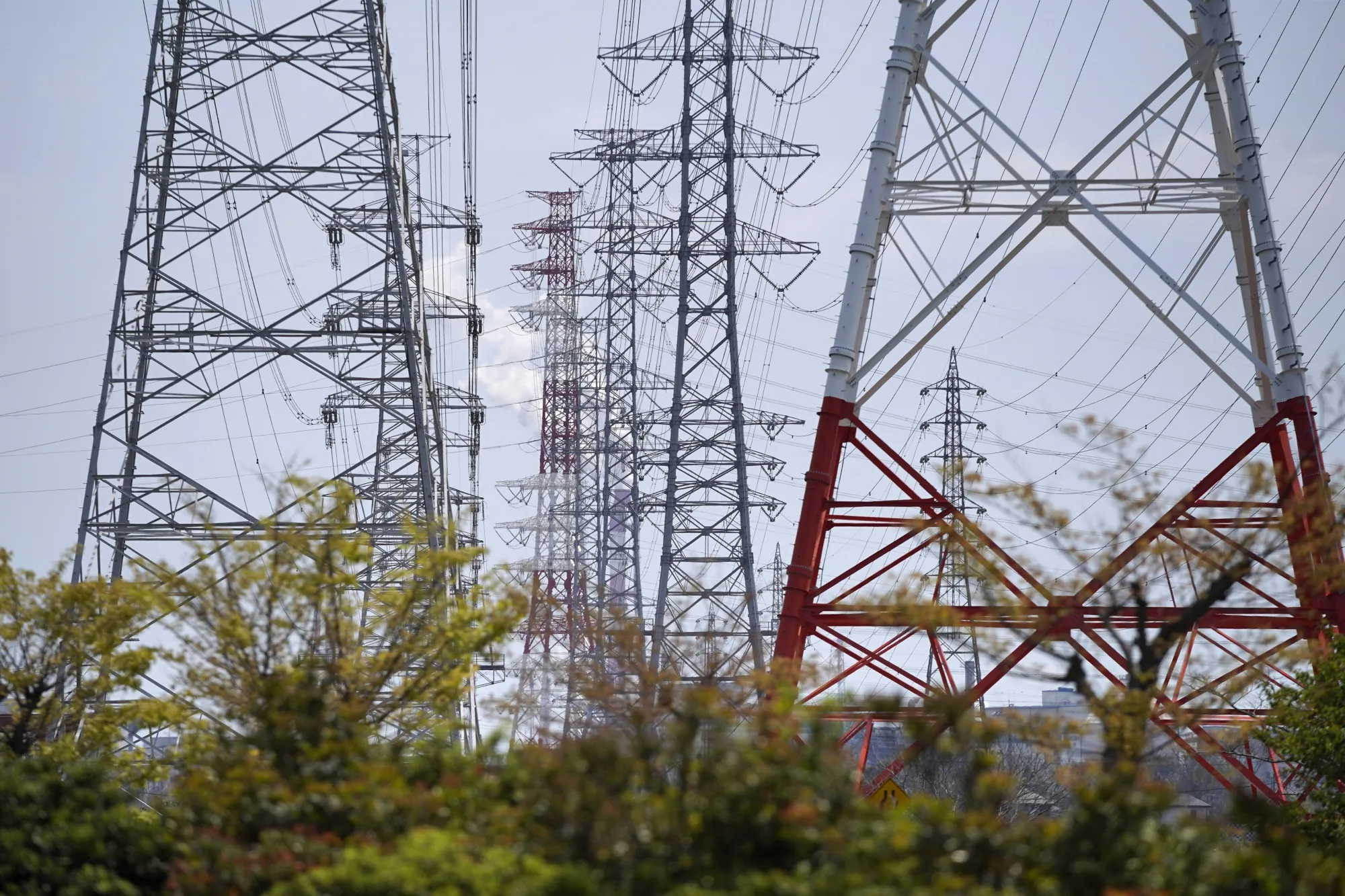 Electrical power lines hang from transmission pylons in Kamisu, Ibaraki Prefecture, Japan.