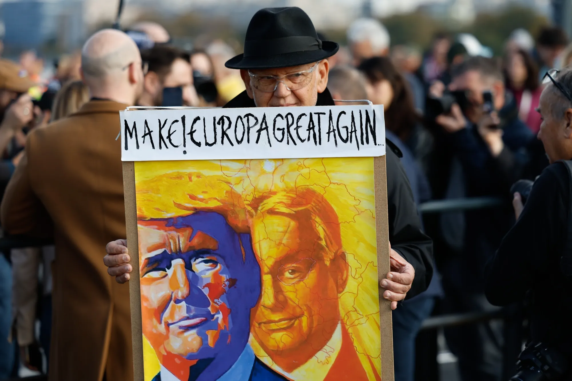 An Orban supporter holds a sign at a rally in Budapest on Oct. 23.
