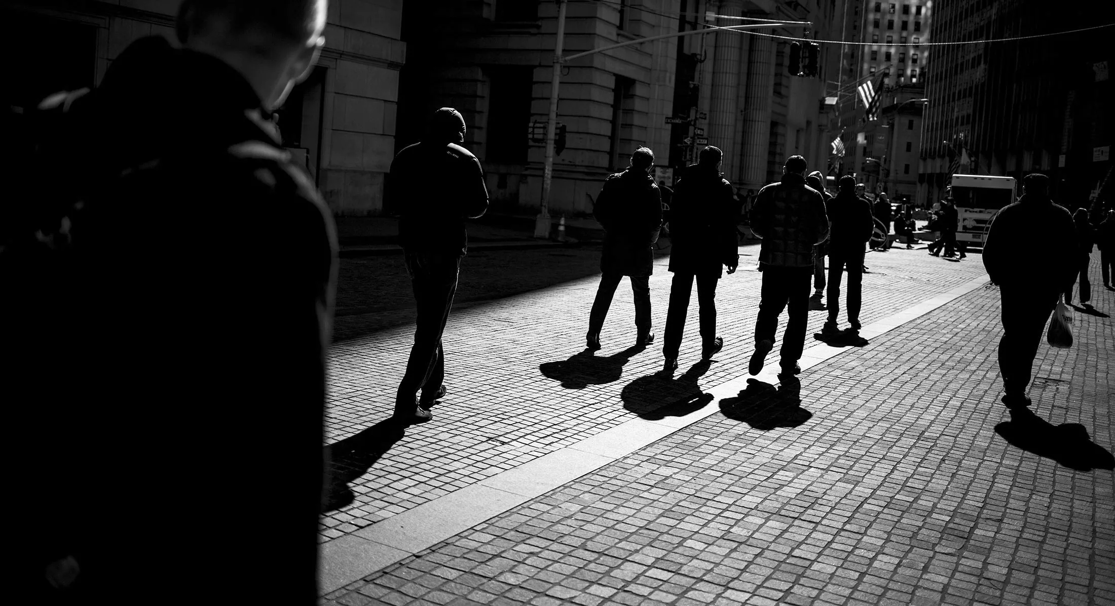 Pedestrians walk past the New York Stock Exchange (NYSE) in New York.