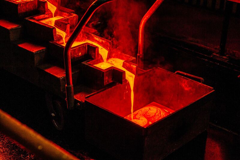 Liquid gold flows from a furnace into individual casting molds to create 28 kilogram gold bars at a Gold Fields Ltd. mine.&nbsp;