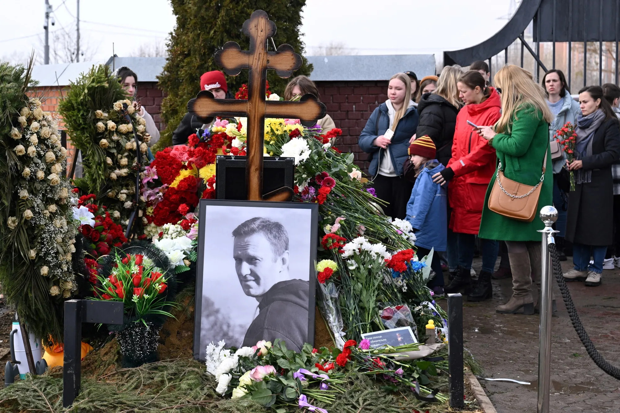 People pay tribute at the grave of Alexei Navalny&nbsp;in Moscow on March 17.