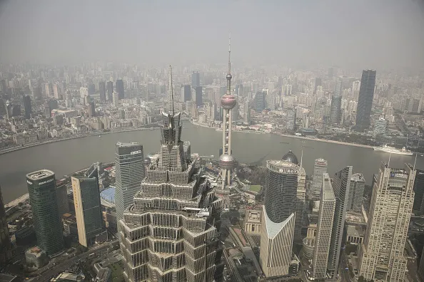 The Jin Mao Tower, foreground, the Oriental Pearl Tower, center, and other buildings are seen from the Shanghai World Financial Center in Shanghai.