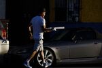 A food delivery driver picks up a pizza from a restaurant in Los Angeles.