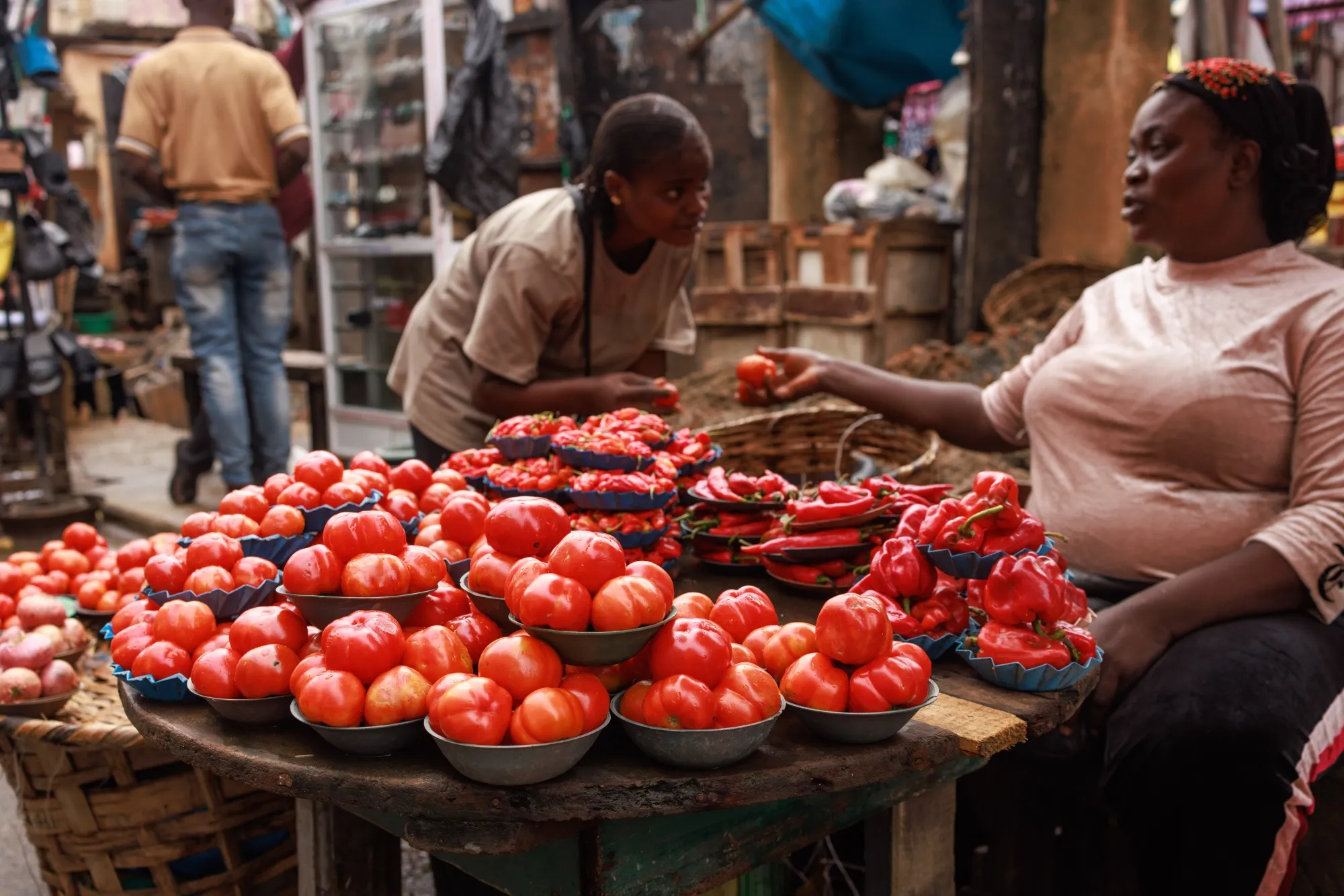 A vendor sells tomatoes and peppers at Yaba market in Lagos, Nigeria.