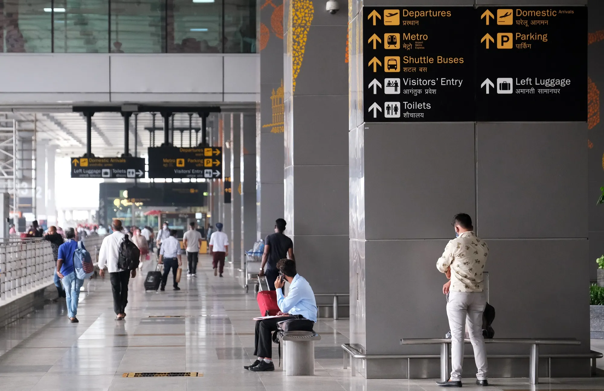 Travelers at Indira Gandhi International Airport in New Delhi.