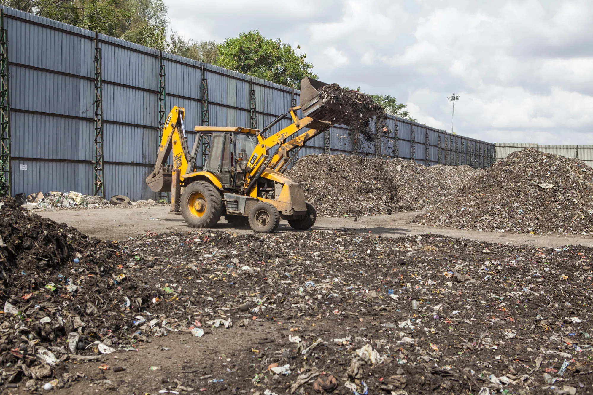 A front loader moves non-segregated waste at the IL&amp;FS compost plant in Mysuru, Karnataka, India. The reach of IL&amp;FS, and its looming&nbsp;cash crunch, hold reminders of the 2008 financial crisis.