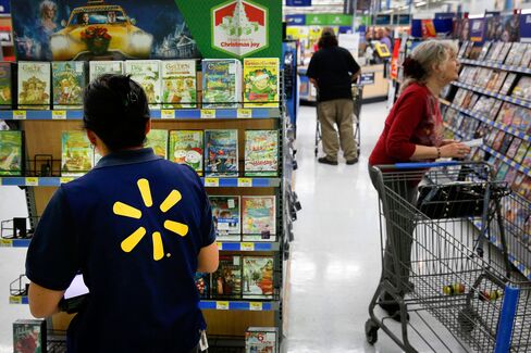 An employee organizes movies for sale at a Wal-Mart store in Los Angeles, California.