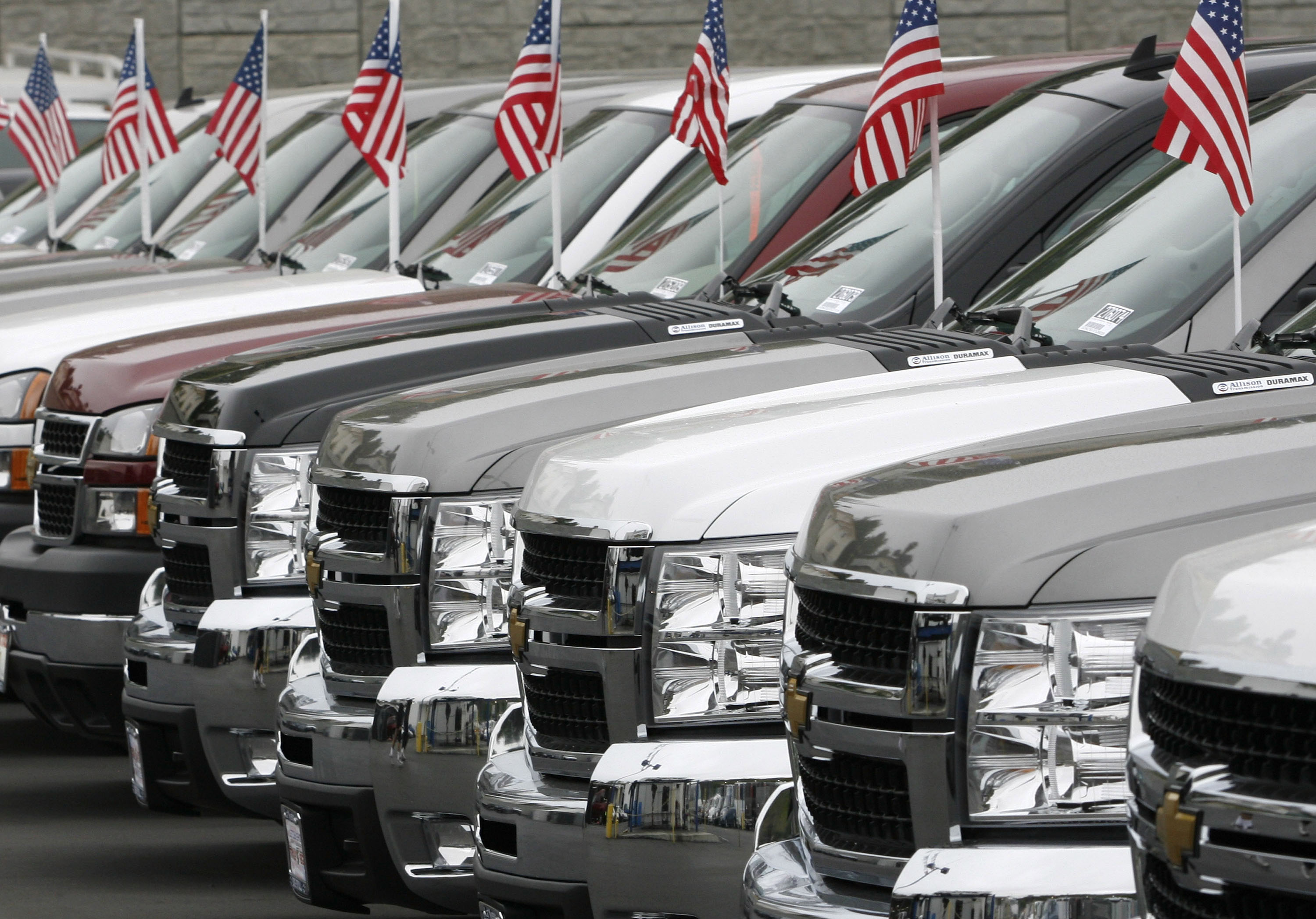 Pickup trucks with American flags affixed to their attennas