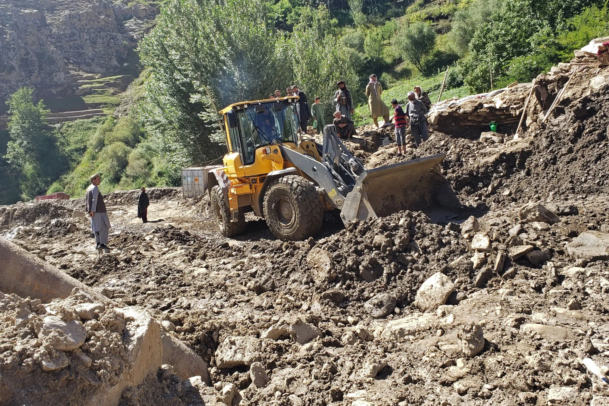 A bulldozer clears a road that was damaged by recent flash floods in Panjshir province, Afghanistan on Aug. 29.