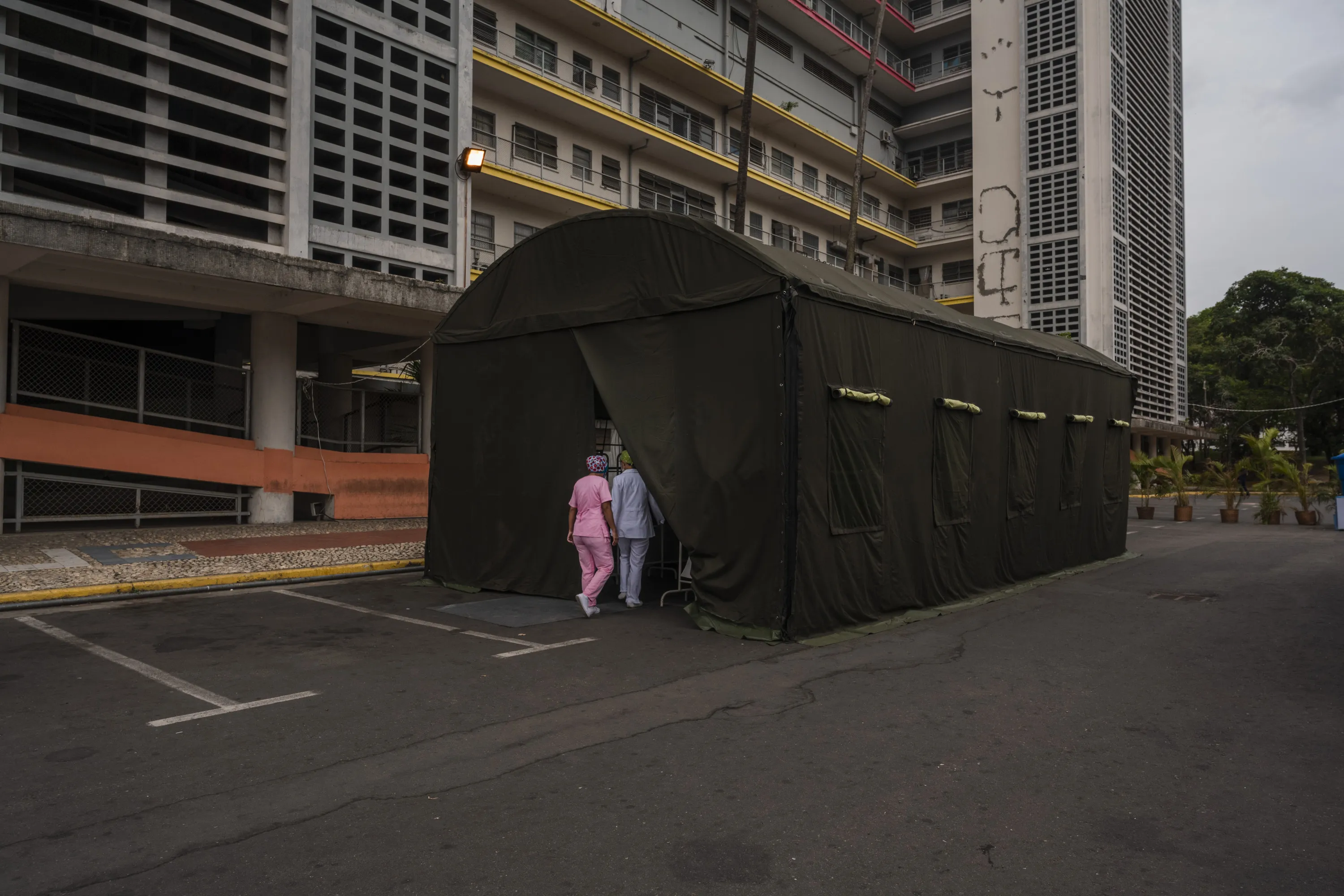 Medical workers enter a field hospital in Caracas on April 4.