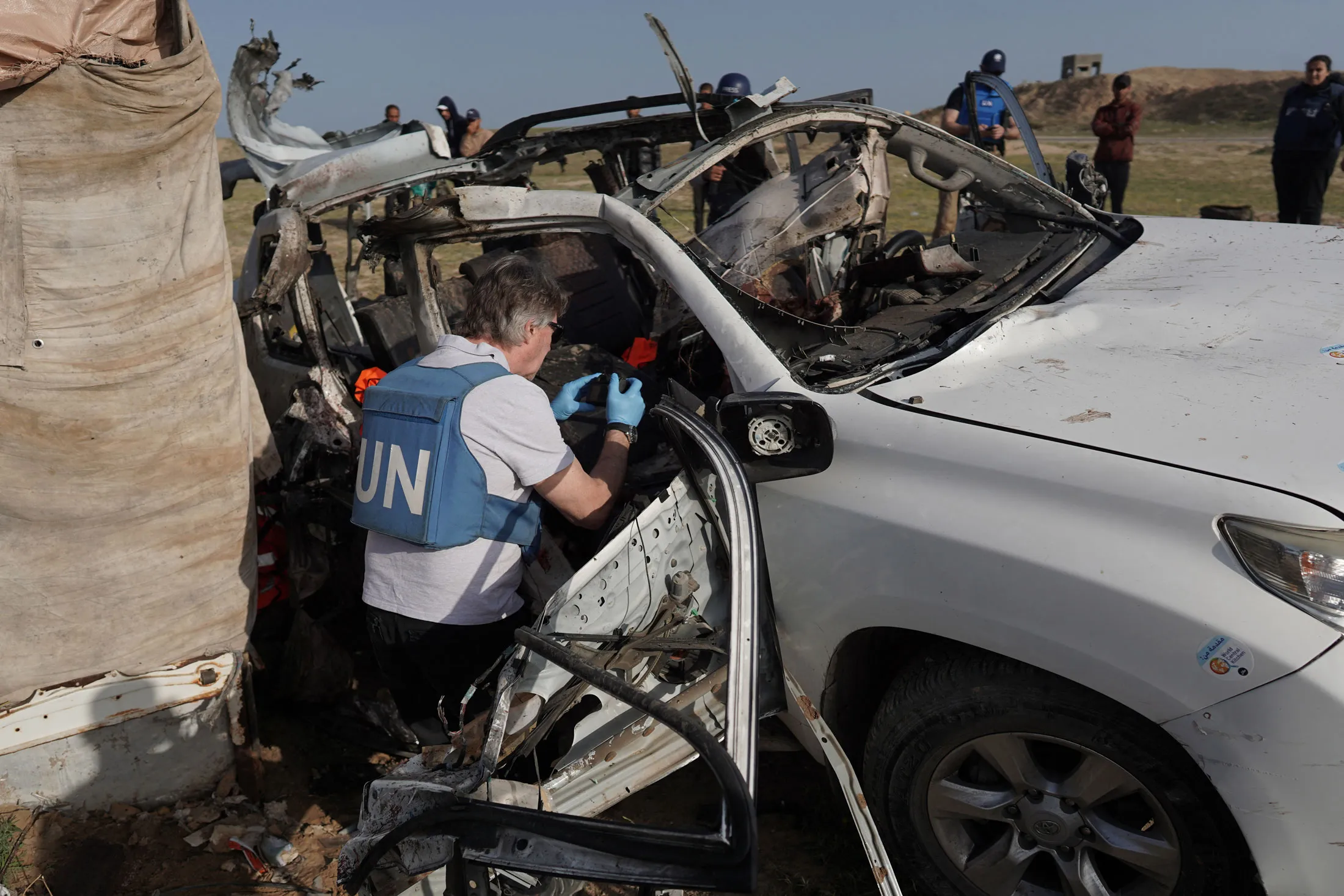 UN staff inspect a damaged World Central Kitchen vehicle in Gaza, on April 2.