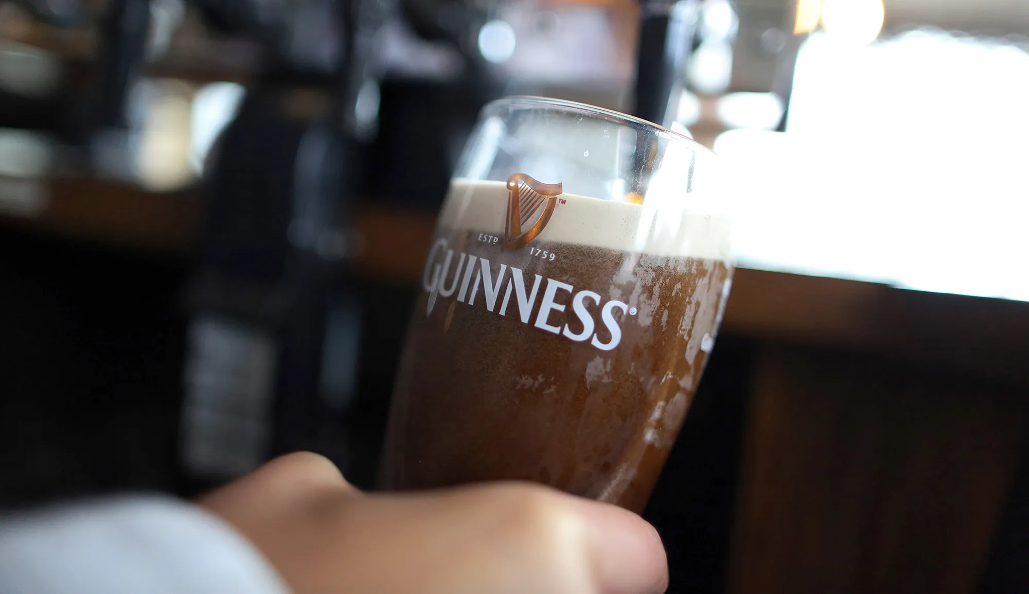 An employee pulls a pint of Guinness stout at The Honor Oak public house, operated by Punch Taverns Plc, in London.