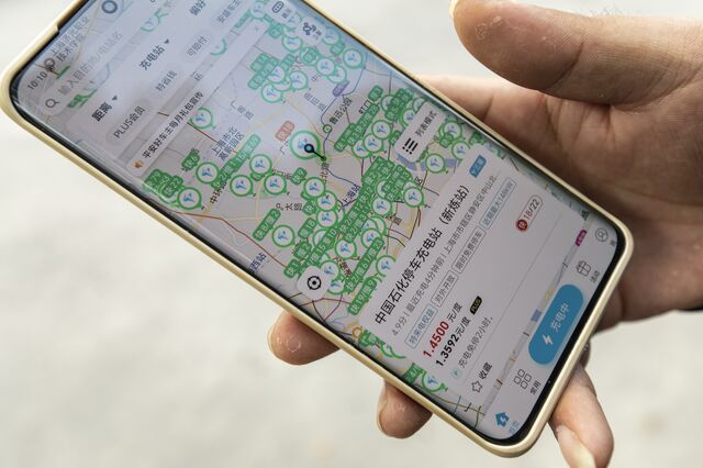 A phone showing a map of charger stations nearby in Shanghai.