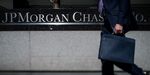 A man carrying a briefcase walks past the JPMorgan Chase & Co. headquarters in New York.
