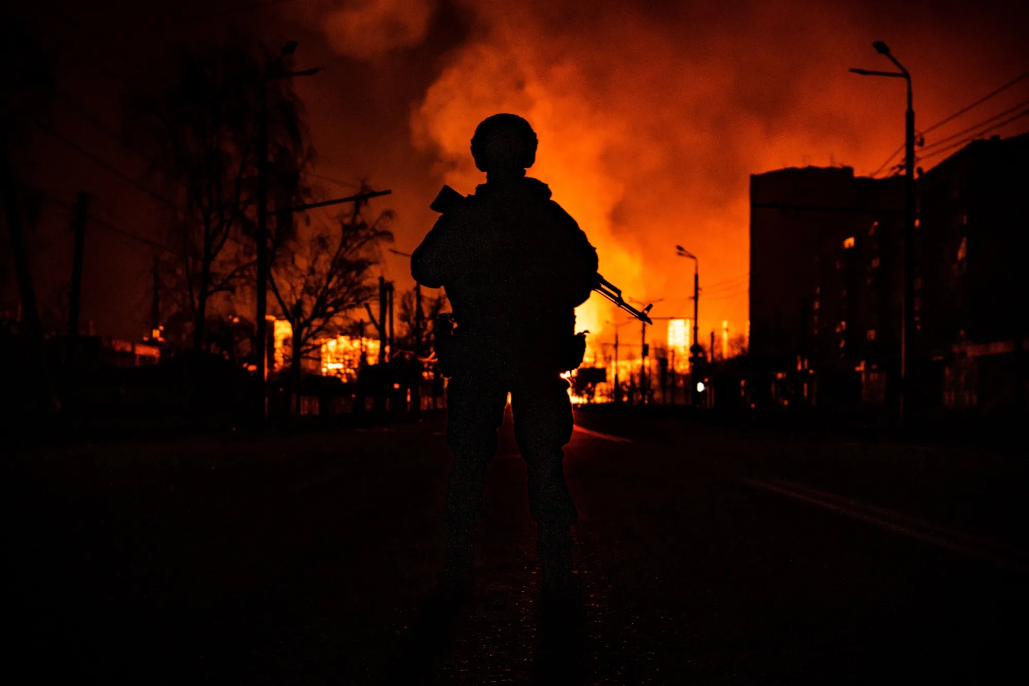 A member of the Ukrainian special forces&nbsp;stands while a gas station burns after Russian attacks in the city of Kharkiv on March 30.