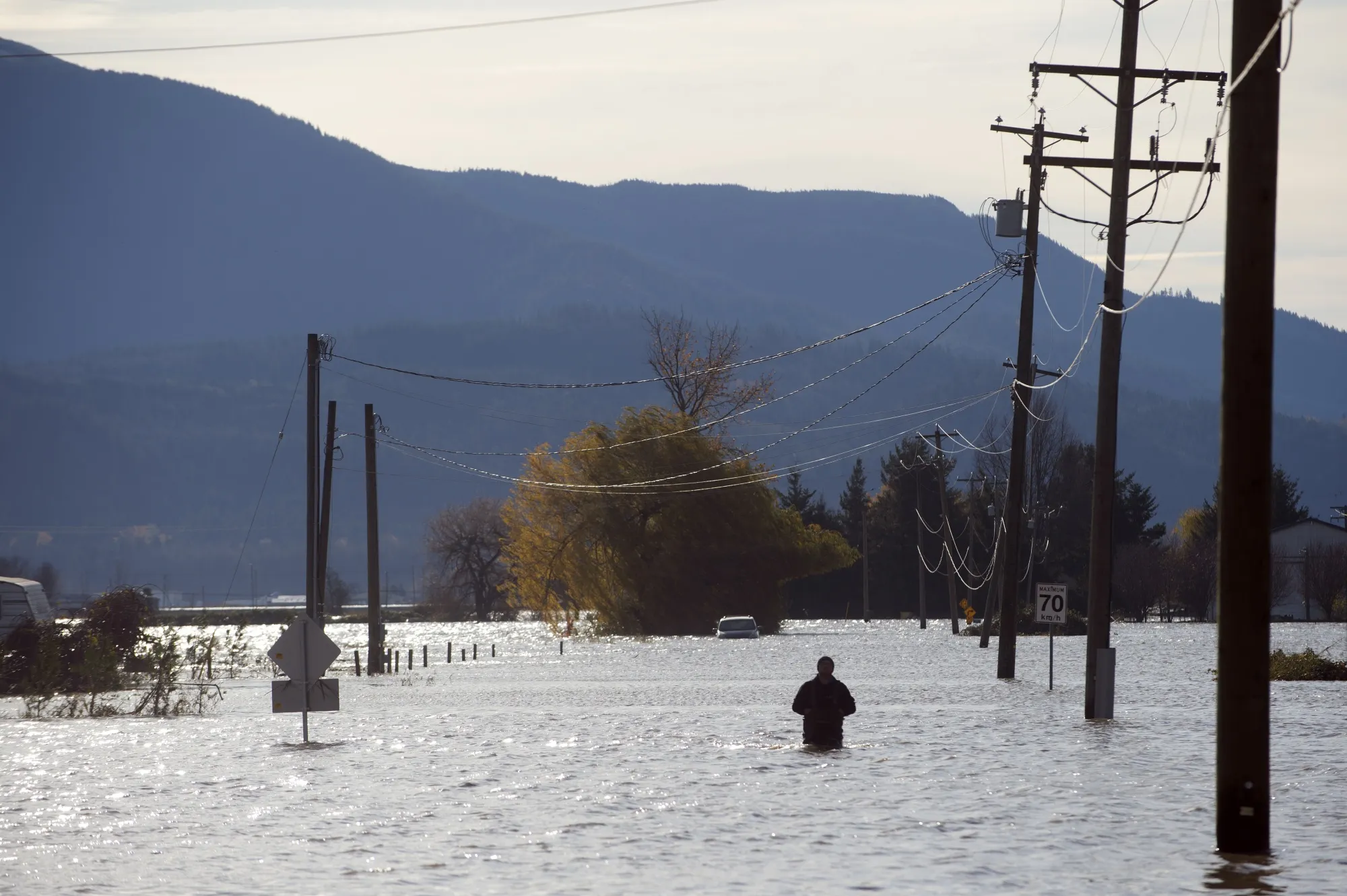 A resident walks through the flooded Sumas Prairie in Abbotsford, British Columbia, Canada, on Nov. 17.