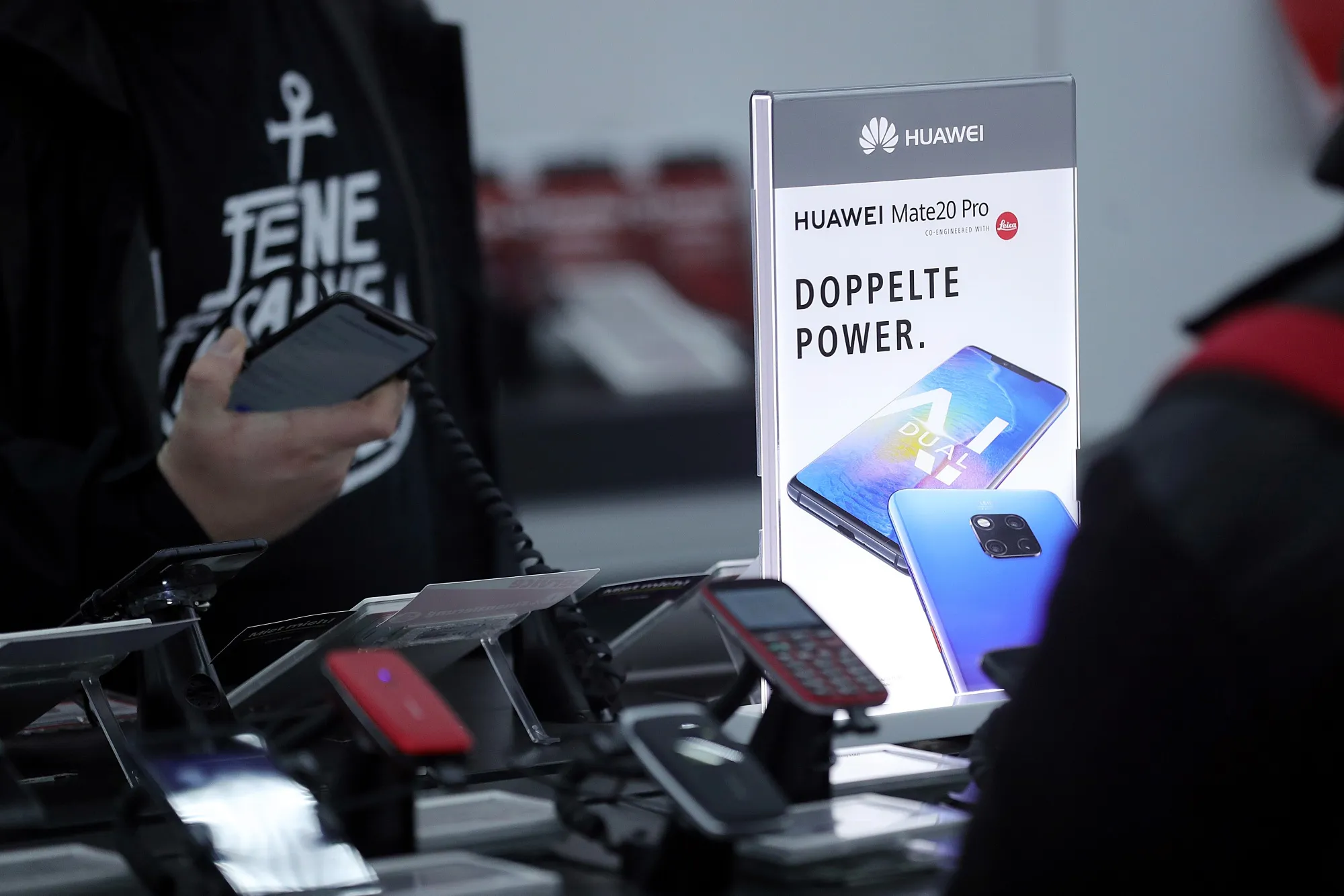 A customer inspects a Huawei Technologies Co. Mate20 Pro smartphone inside an electronic goods store in Berlin.