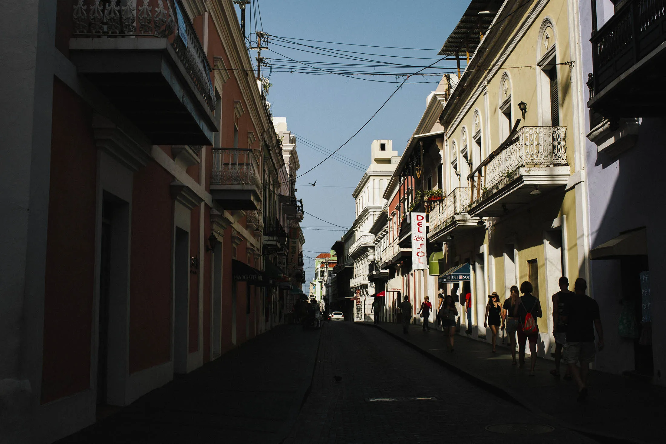 People walk on a street in Old San Juan, Puerto Rico.
